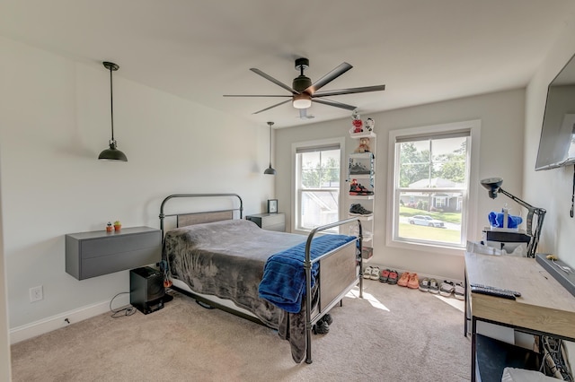 bedroom with carpet flooring, baseboards, and a ceiling fan
