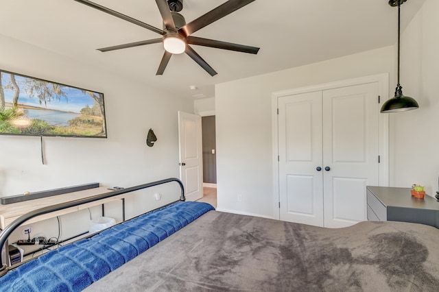 bedroom with carpet, a closet, baseboards, and ceiling fan