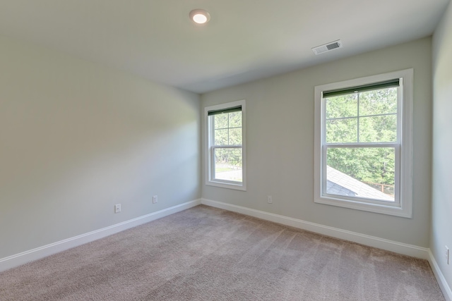 empty room with baseboards and light carpet