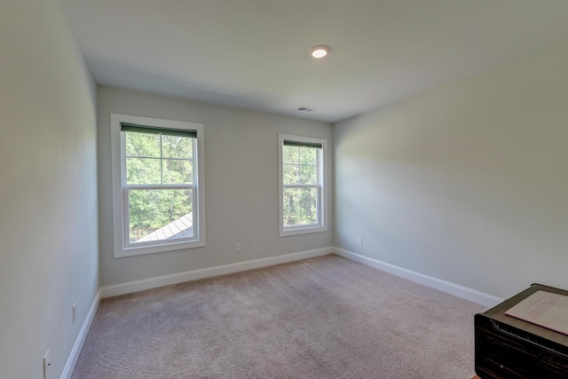 carpeted spare room with baseboards