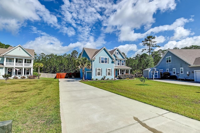 view of front of property featuring concrete driveway, a storage unit, a balcony, an outbuilding, and covered porch