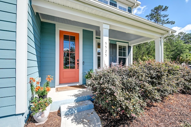 view of exterior entry featuring a porch