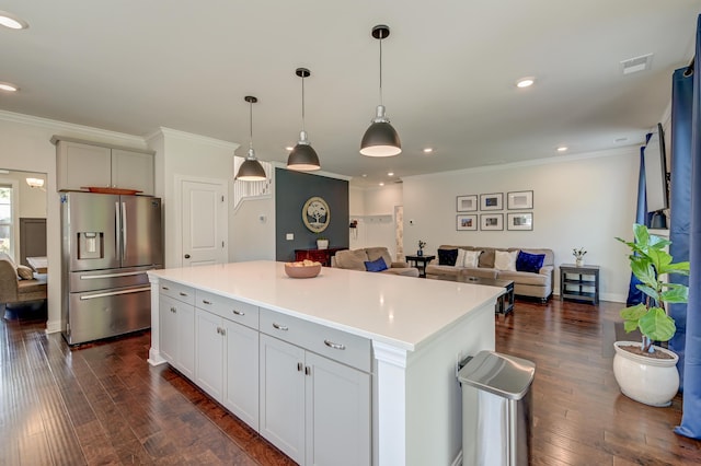 kitchen with stainless steel fridge, dark wood-style floors, crown molding, open floor plan, and recessed lighting