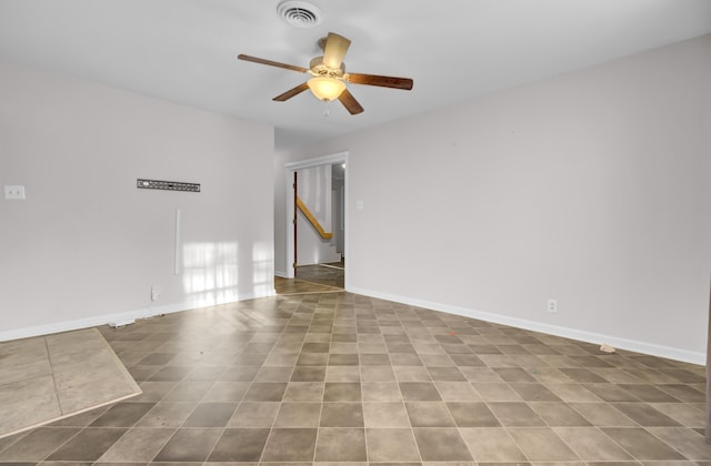 tiled empty room featuring ceiling fan