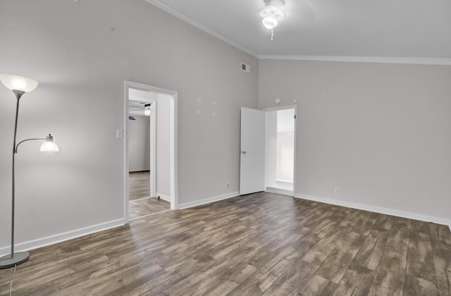 unfurnished bedroom with dark hardwood / wood-style flooring, crown molding, and a towering ceiling