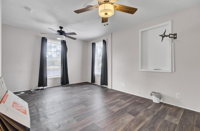 empty room with ceiling fan and dark hardwood / wood-style flooring