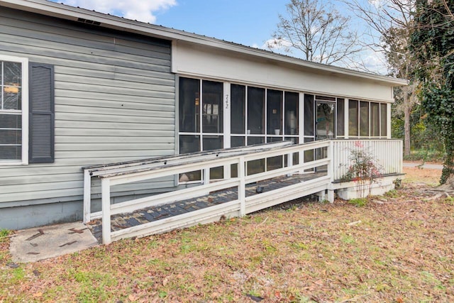 view of side of home with a sunroom