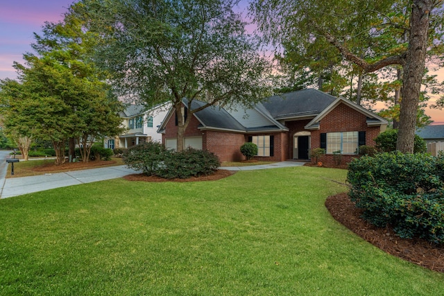 view of front of home featuring a yard and a garage