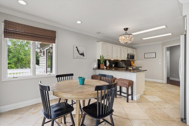 dining space with a chandelier, ornamental molding, recessed lighting, and baseboards