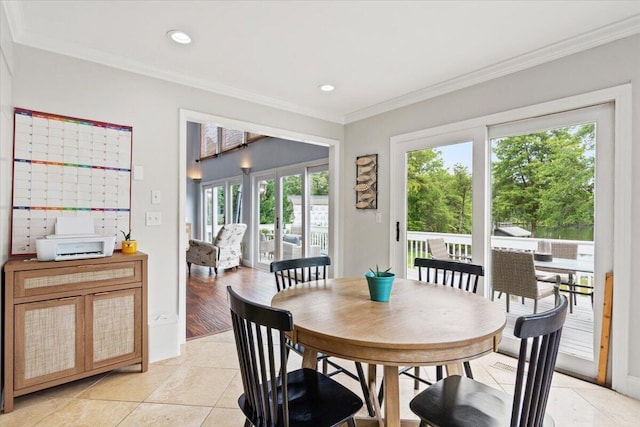 dining room featuring healthy amount of natural light, ornamental molding, recessed lighting, and light tile patterned floors