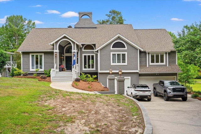 view of front of home with an attached garage, driveway, roof with shingles, and a front yard