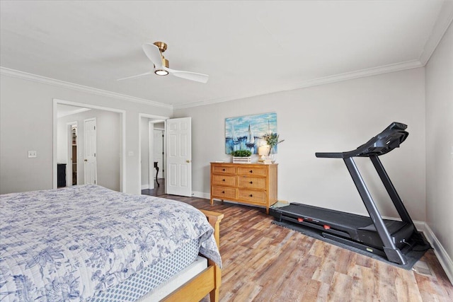 bedroom with wood finished floors, ornamental molding, baseboards, and a ceiling fan
