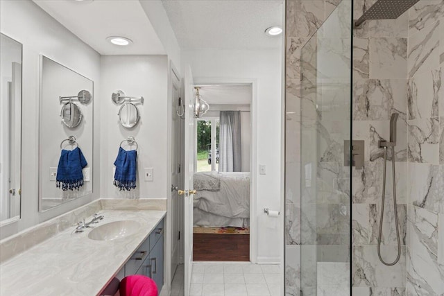 ensuite bathroom with a marble finish shower and vanity