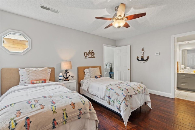 bedroom featuring hardwood / wood-style flooring, baseboards, ceiling fan, a textured ceiling, and ensuite bathroom