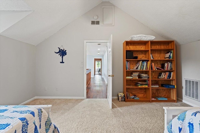 carpeted bedroom with lofted ceiling, a textured ceiling, and baseboards