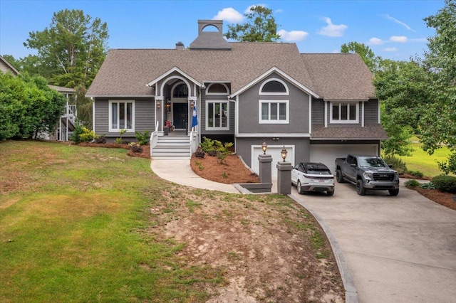 view of front facade featuring driveway, a garage, a front yard, and roof with shingles