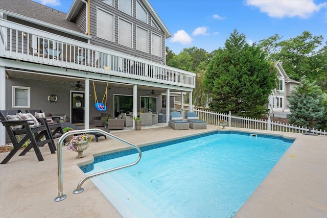 view of swimming pool featuring an outdoor hangout area, a ceiling fan, fence, and a patio