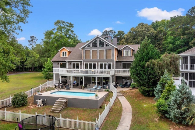 rear view of property featuring a chimney and a patio
