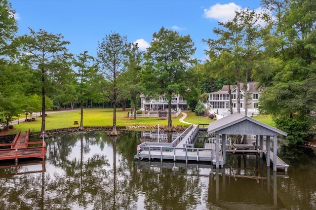 dock featuring a water view, a yard, view of scattered trees, and boat lift