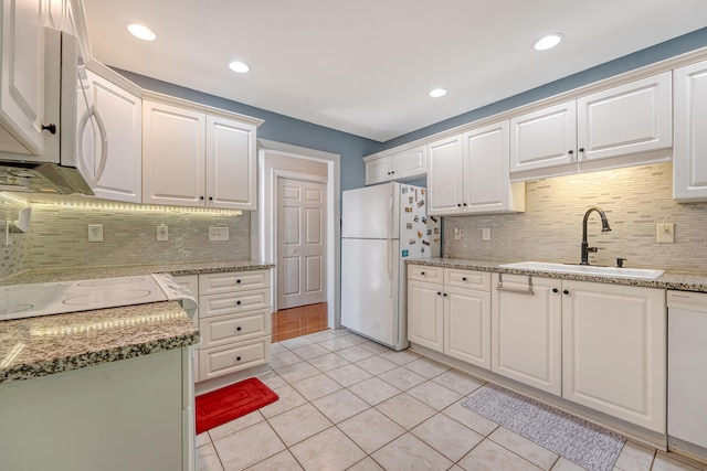 9117 Woodcreek Ct, North Charleston, SC 29406 - kitchen with white appliances, tasteful backsplash, white cabinetry, light tile patterned flooring, and recessed lighting