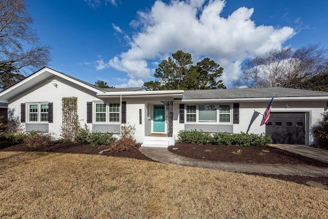 single story home with a garage and a front yard