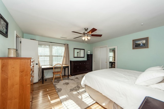 bedroom with light hardwood / wood-style flooring, a closet, and ceiling fan