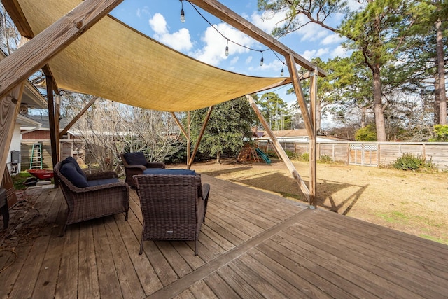 wooden deck with a playground and an outdoor hangout area