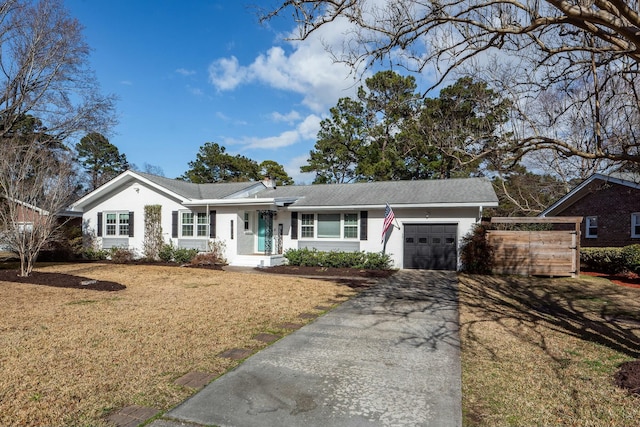 ranch-style house with a garage and a front lawn