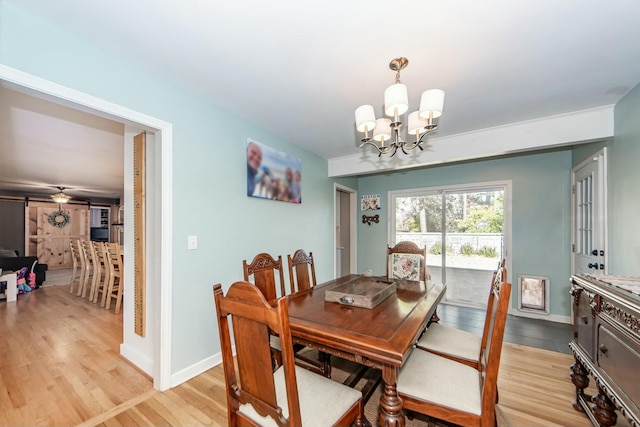 dining space featuring a chandelier and light wood-type flooring