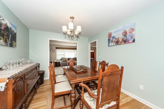 dining area featuring a notable chandelier and light hardwood / wood-style floors