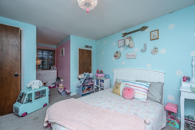 bedroom with visible vents, baseboards, a textured ceiling, and carpet flooring