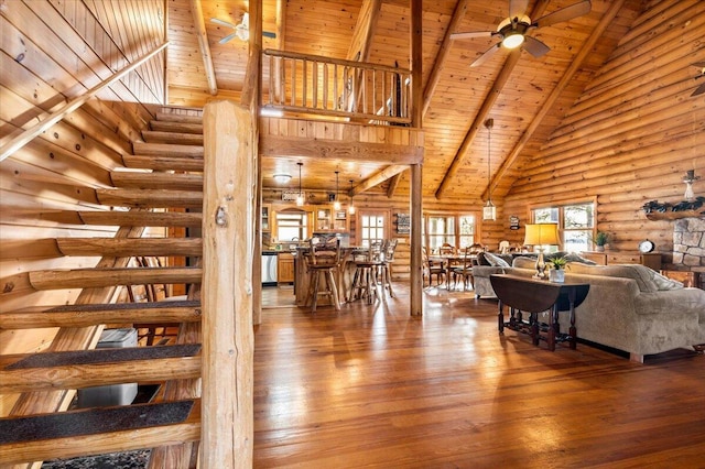 3550 Princess Pond Rd, Summerton, SC 29148 - living room featuring high vaulted ceiling, wooden ceiling with exposed beams, log walls, stairs, and ceiling fan