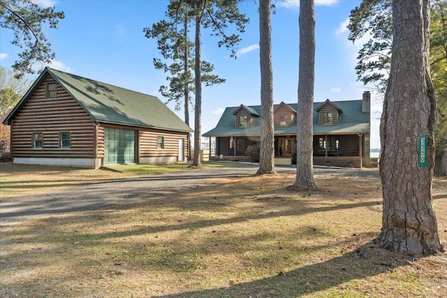 3550 Princess Pond Rd, Summerton, SC 29148 - log home with a front lawn and a detached garage
