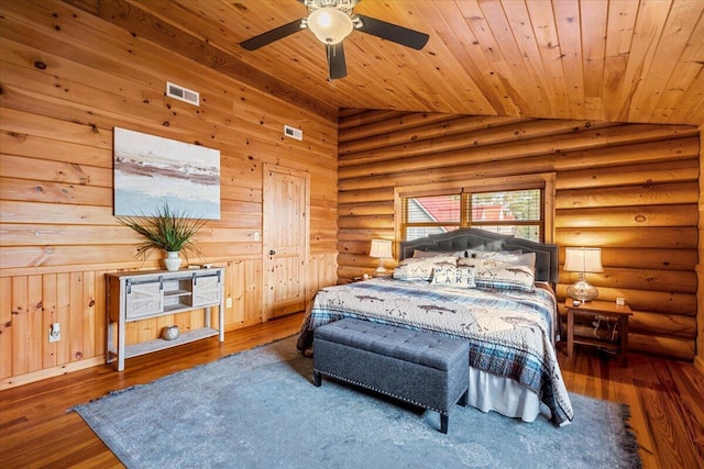 3550 Princess Pond Rd, Summerton, SC 29148 - bedroom with lofted ceiling, wood ceiling, rustic walls, and wood finished floors