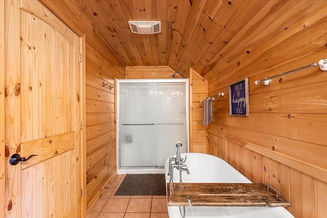 3550 Princess Pond Rd, Summerton, SC 29148 - full bathroom featuring wooden walls, tile patterned floors, a freestanding bath, and a stall shower