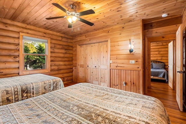 3550 Princess Pond Rd, Summerton, SC 29148 - bedroom with hardwood / wood-style flooring, wood ceiling, and log walls