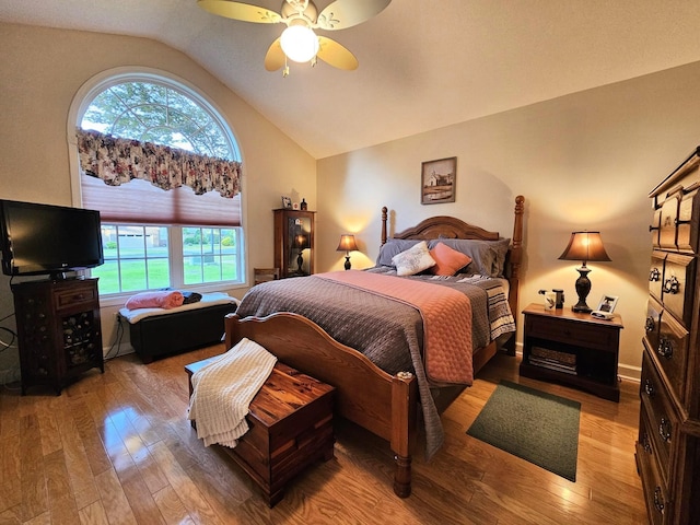 bedroom featuring vaulted ceiling, wood finished floors, and a ceiling fan