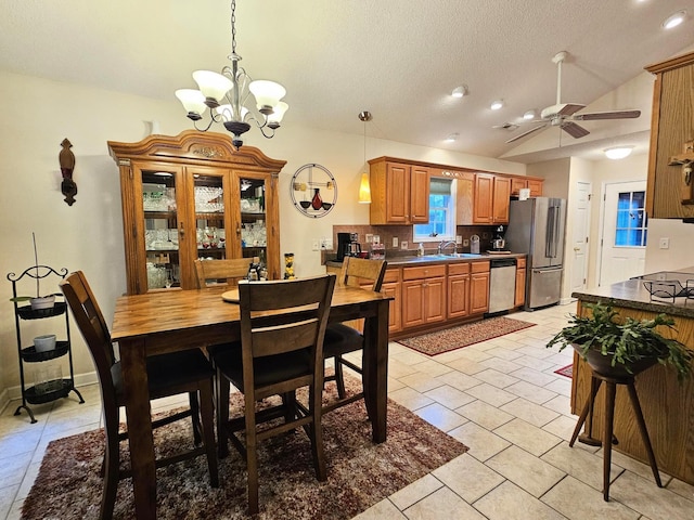 dining area with a chandelier, vaulted ceiling, ceiling fan, a textured ceiling, and recessed lighting