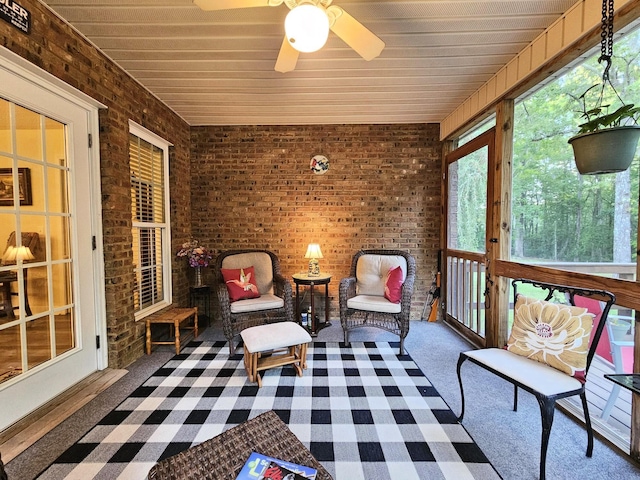 sunroom / solarium featuring ceiling fan