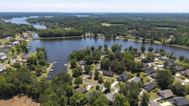view of property location featuring a heavily wooded area and a large body of water