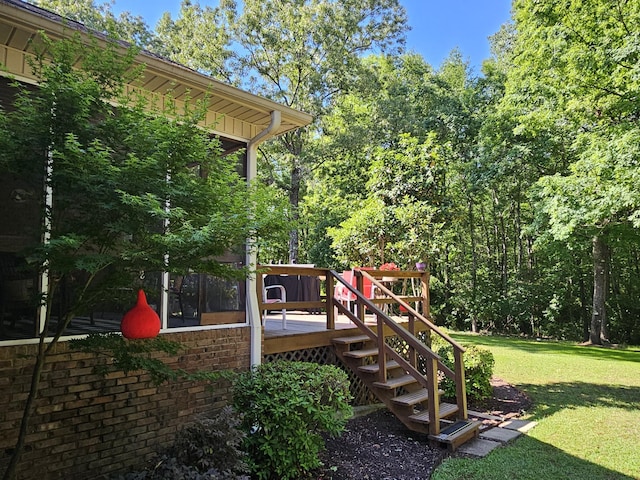 view of play area with a yard, a wooden deck, and stairs