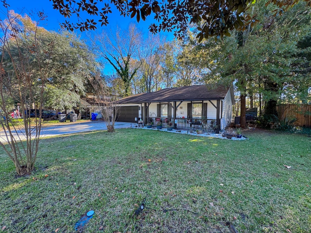 view of yard with a porch and a garage