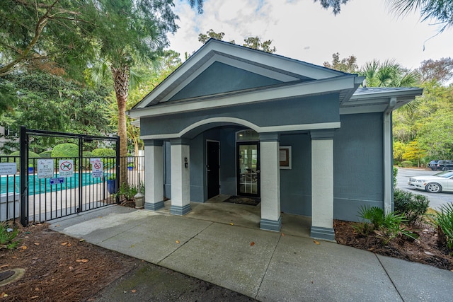 entrance to property with a community pool