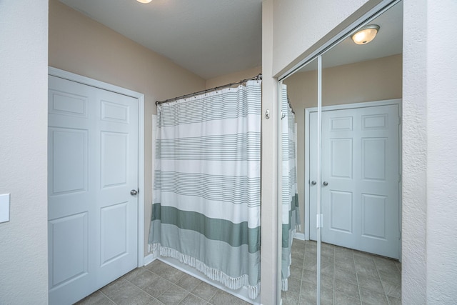 bathroom featuring tile patterned flooring and a shower with shower curtain