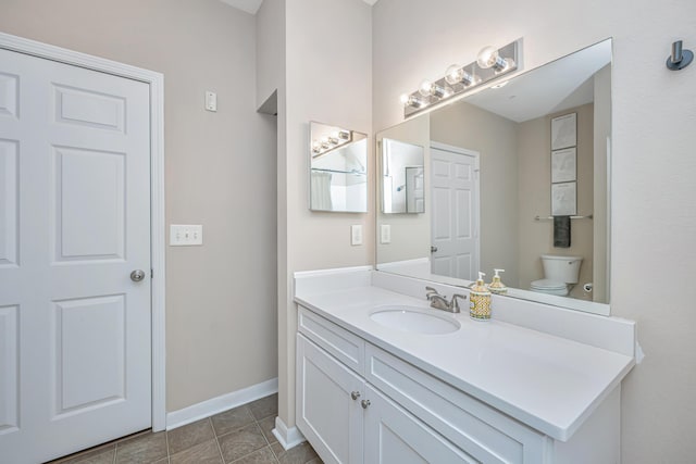 bathroom with vanity, tile patterned floors, and toilet