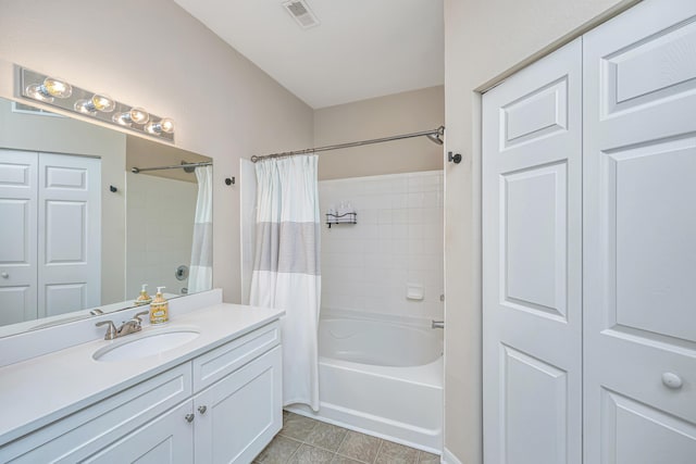 bathroom with tile patterned flooring, vanity, and shower / bath combo with shower curtain