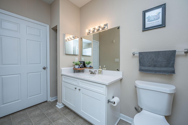 bathroom featuring tile patterned floors, vanity, and toilet