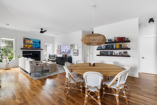 dining space with hardwood / wood-style floors and ceiling fan