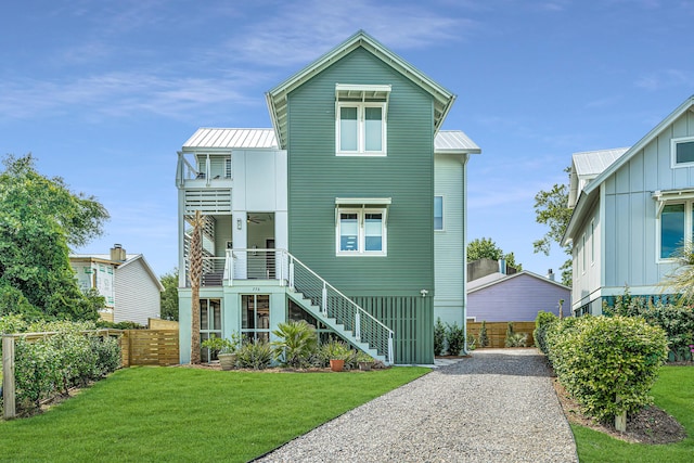 view of front of home featuring a front lawn, a balcony, and a porch