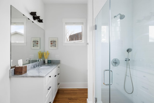 bathroom with vanity, an enclosed shower, and hardwood / wood-style floors